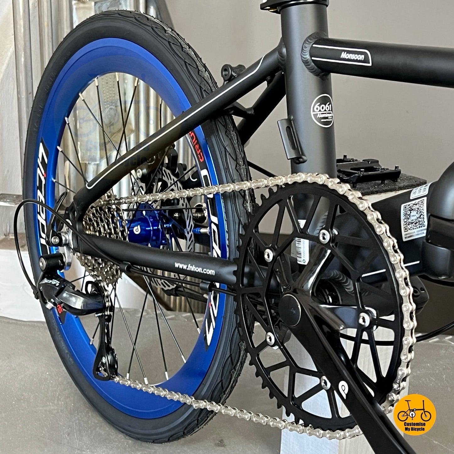 Close up of Fnhon Litepro Hollowtech crankset and hollow 54t chainring Matte Black Blue Monsoon