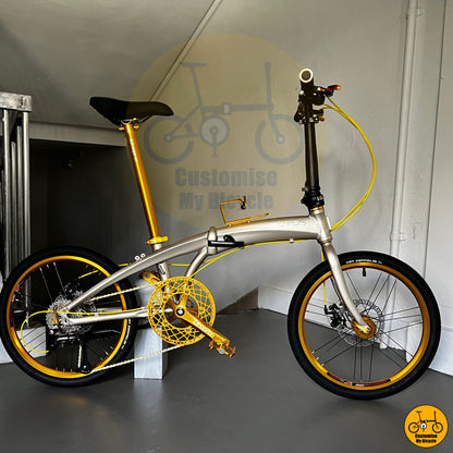 Folding bike with champagne gold frame and golden wheels, ideal for city commuting