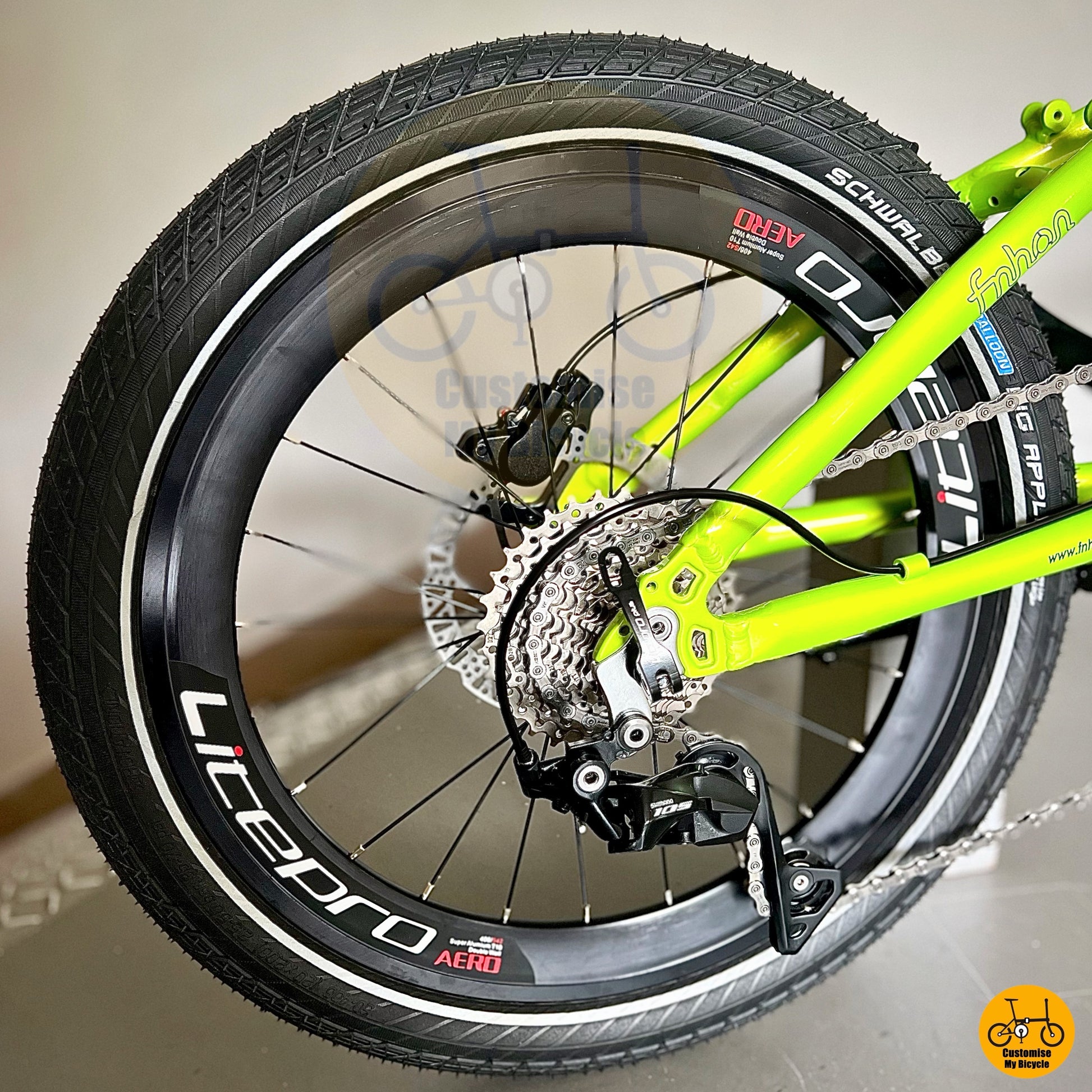 High-contrast apple green foldable bicycle with black saddle and bars
