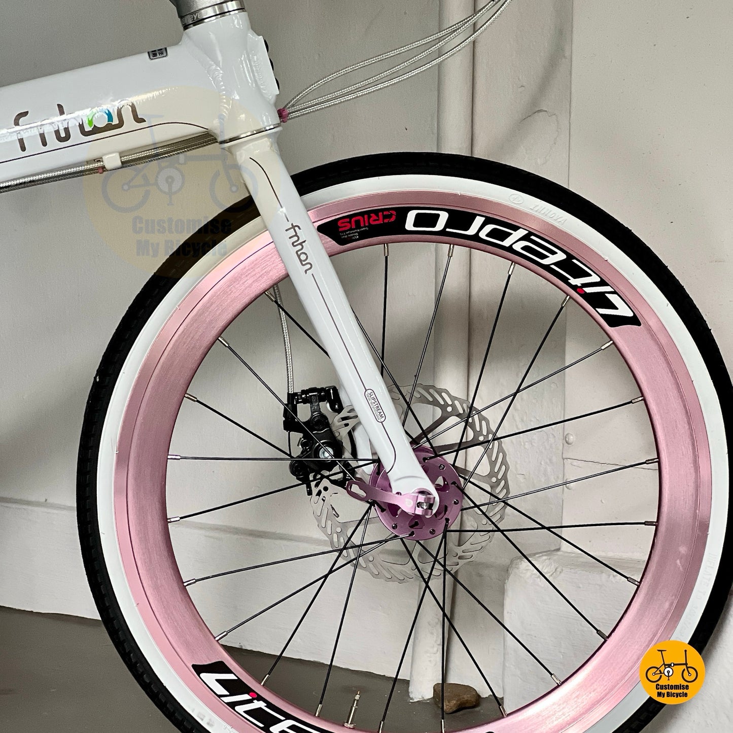 Close up of LITEPRO Aero easy rolling wheelset with CST or INNOVA white wall tyres on folding bicycle