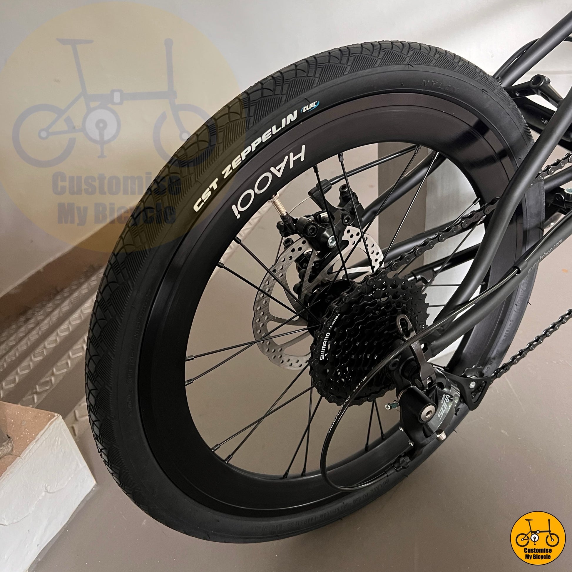 Folding bicycle with city-ready features and aggressive styling
