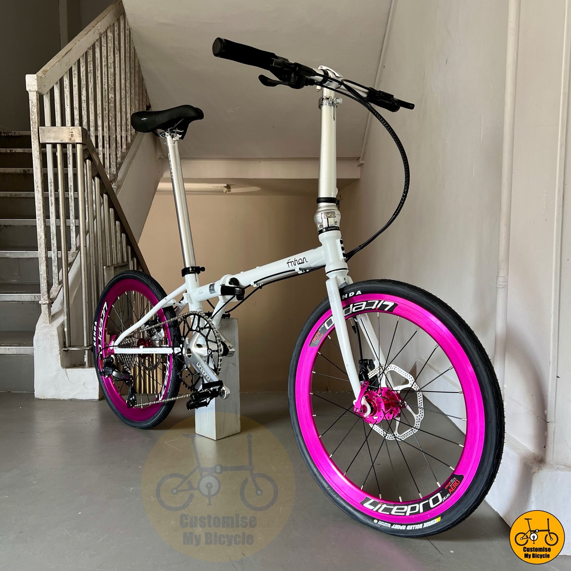 22-inch folding bike with white frame and pink rims
