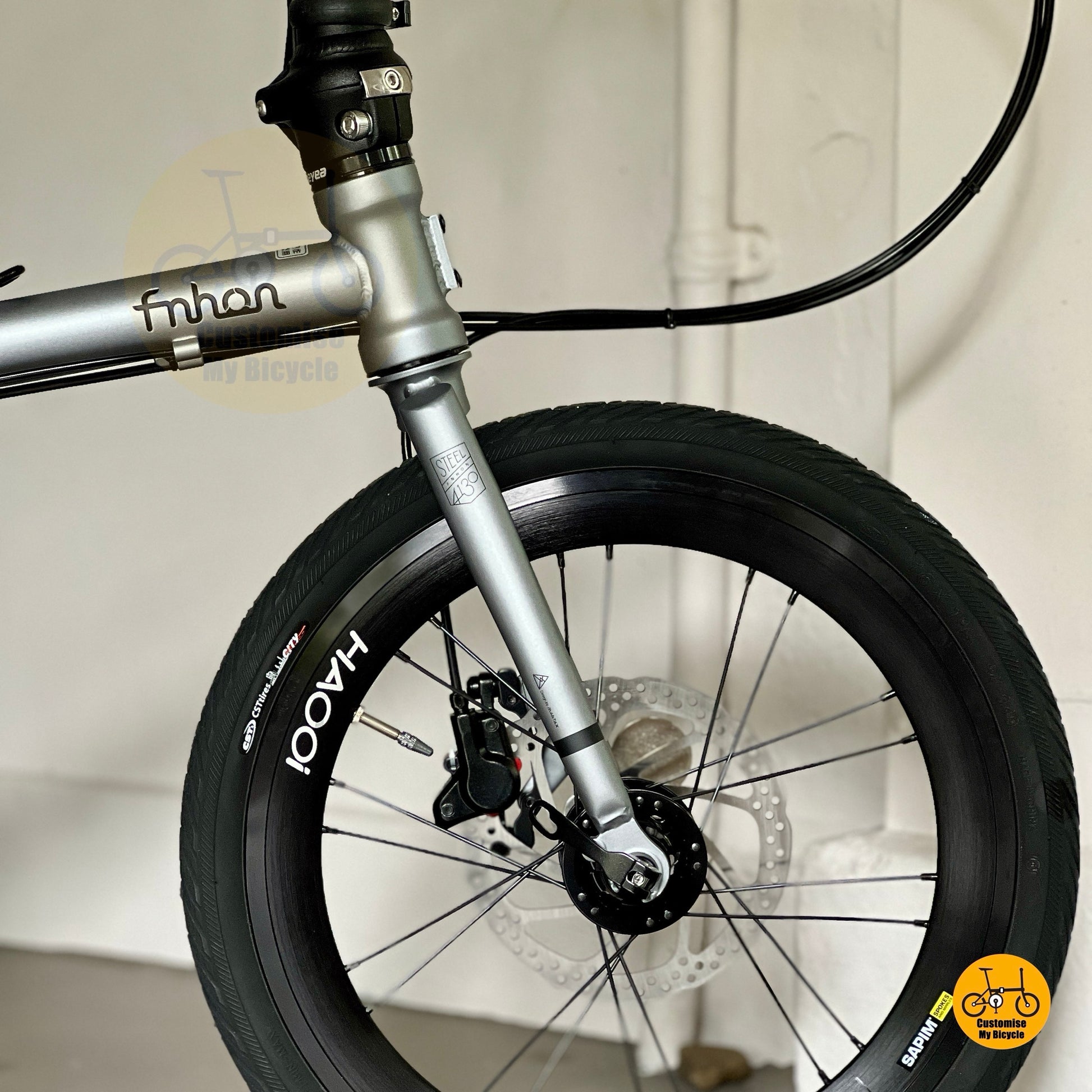 Low angle shot of HAOOI wheel and hydraulic brake setup on Fnhon Gust 18 inch Battleship Grey folding bicycle