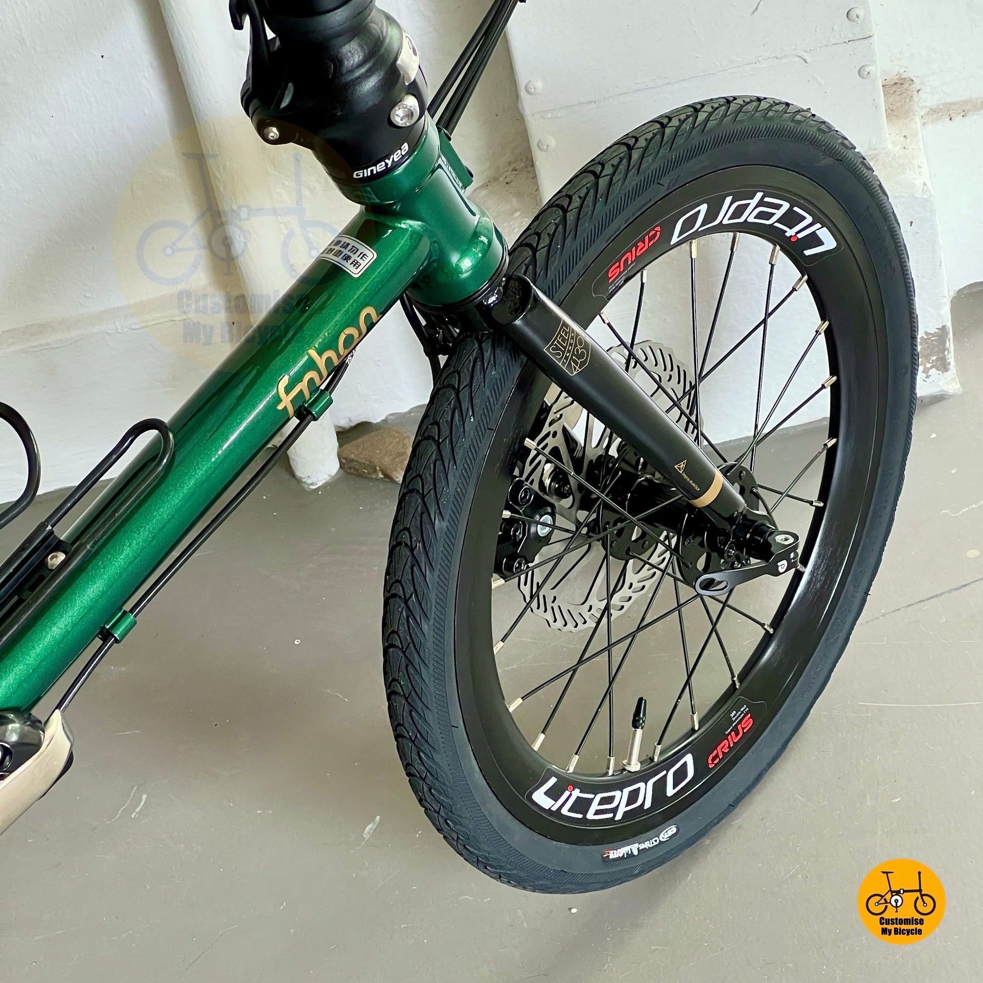 Front wheel close-up of Fnhon Gust 18" showing Litepro aero wheelset and disc brake setup