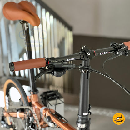 Litepro Glossy Carbon Handlebar close up showing LITEPRO lightweight carbon bar and internal cable routing on the Rose Gold Fnhon Gust