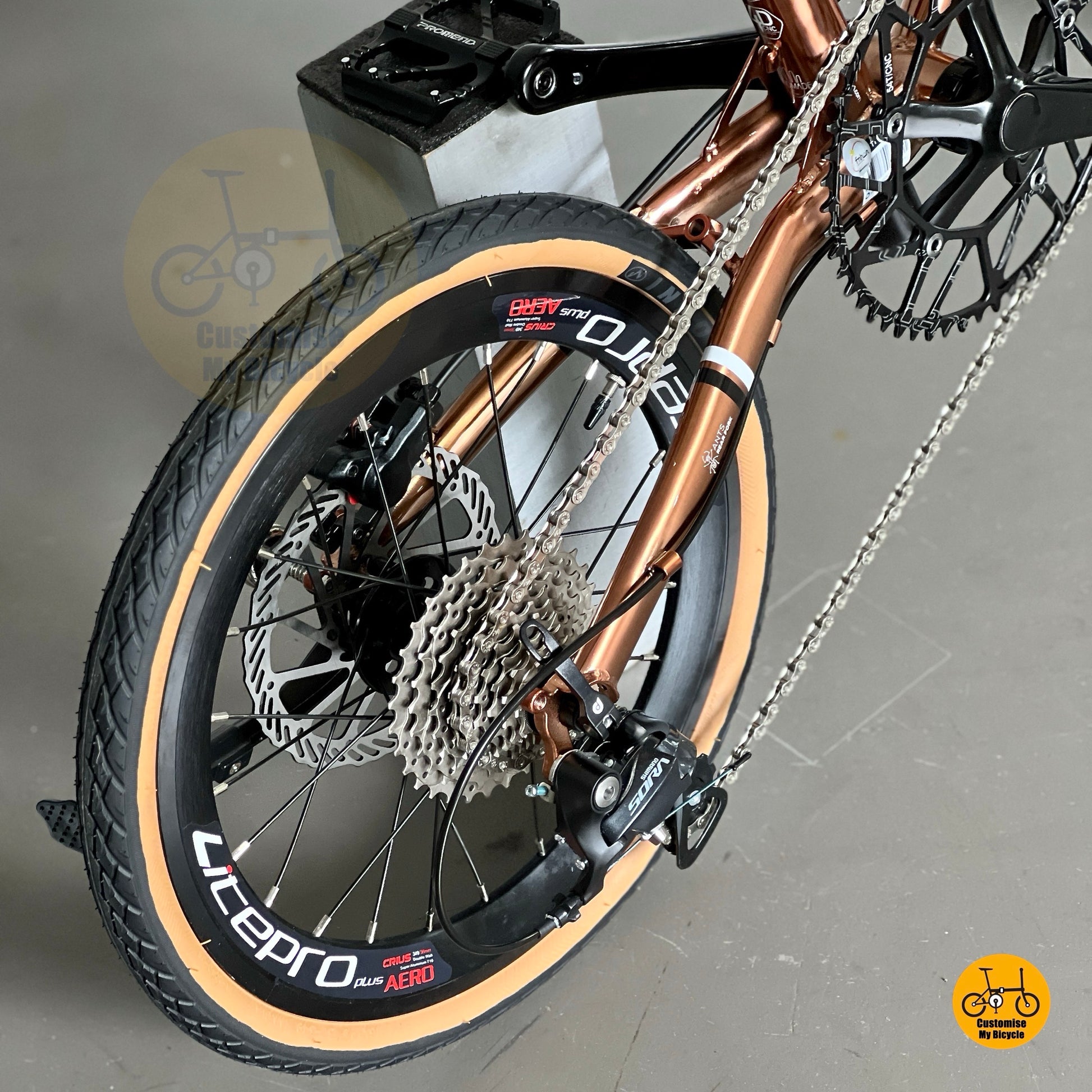 Rear derailleur view showing SHIMANO 9 gears Sora drivetrain on Fnhon Gust 18 inch Rose Gold folding bike