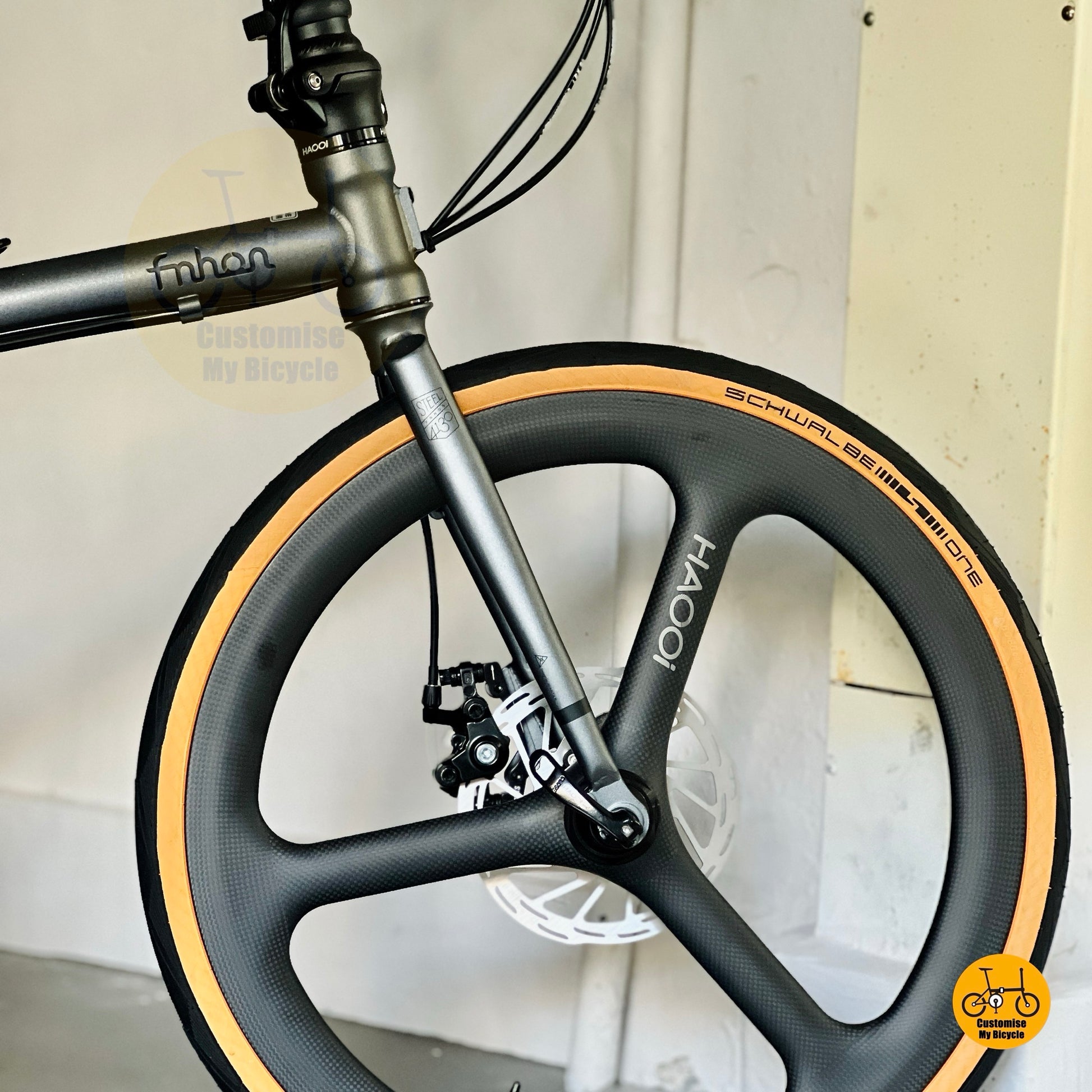 Front wheel close up HAOOI carbon ultra trispoke wheel design folding bicycle