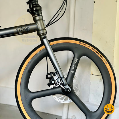 Front wheel close up HAOOI carbon ultra trispoke wheel design folding bicycle