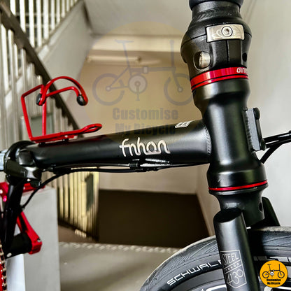 Matte black foldie with smooth pedals and hydraulic disc brakes
