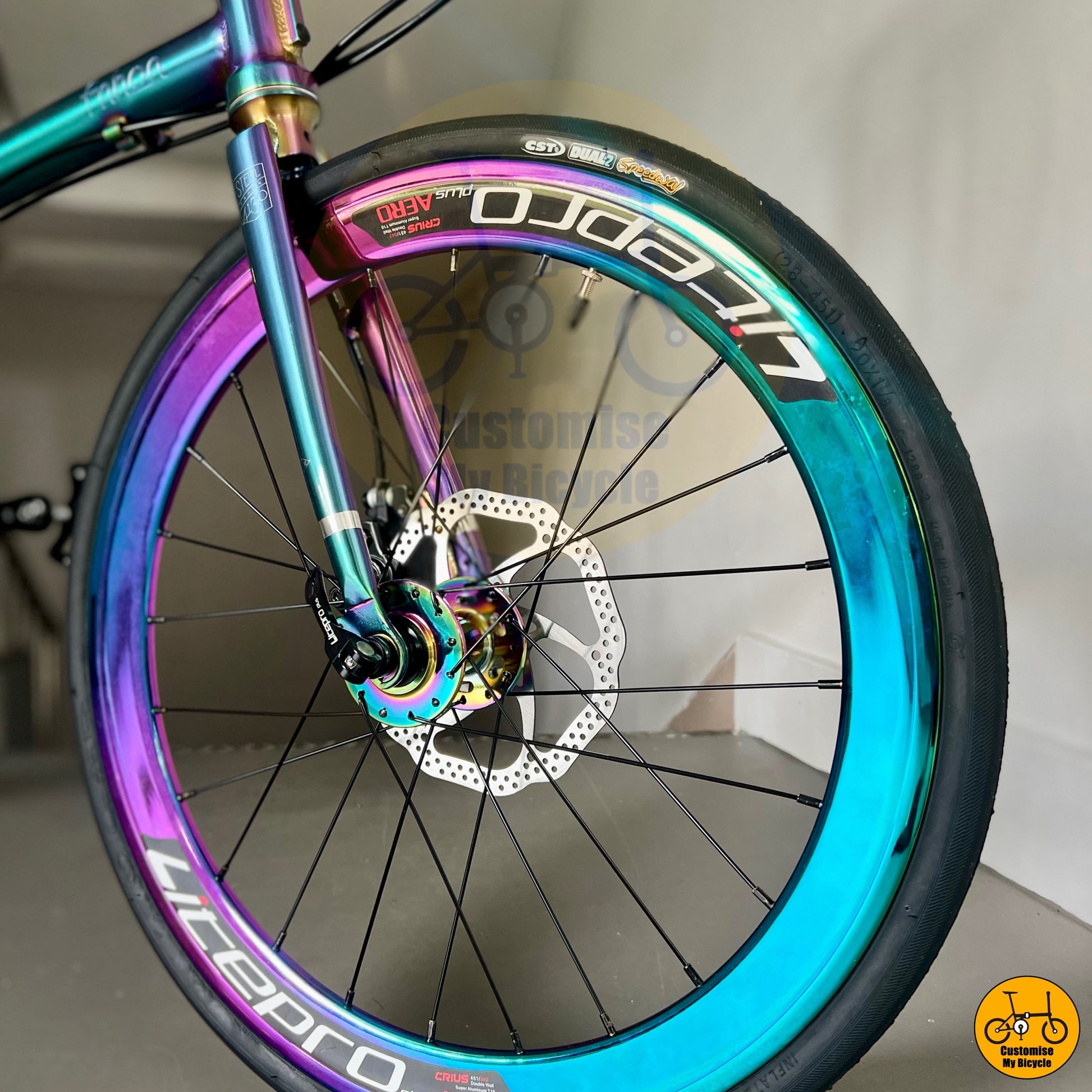 Aurora-themed foldable bicycle with rainbow-colored Litepro wheels
