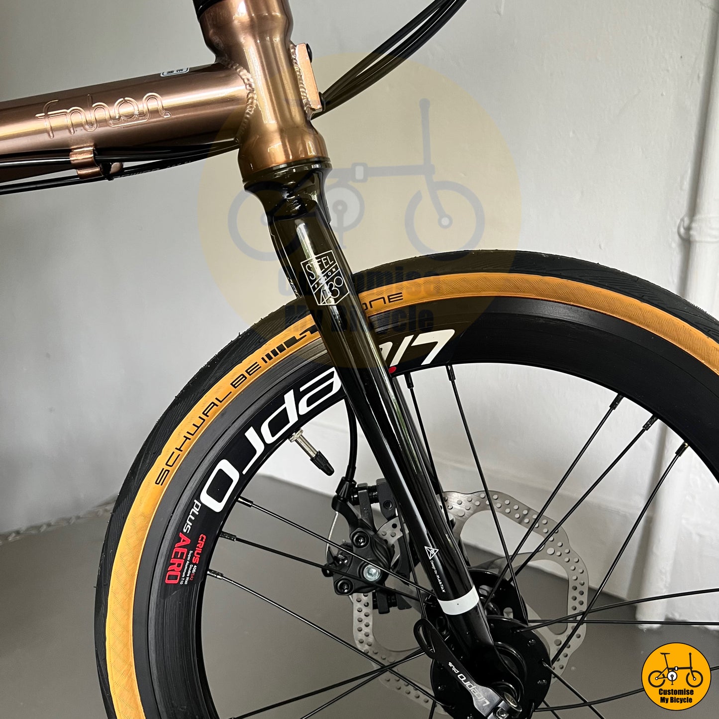 City commuter foldable bike with a stylish rose gold finish

