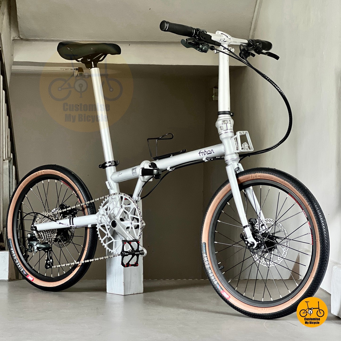 Space Silver Fnhon Gust folding bicycle with brown wall tyres and MT200 hydraulic brakes  
