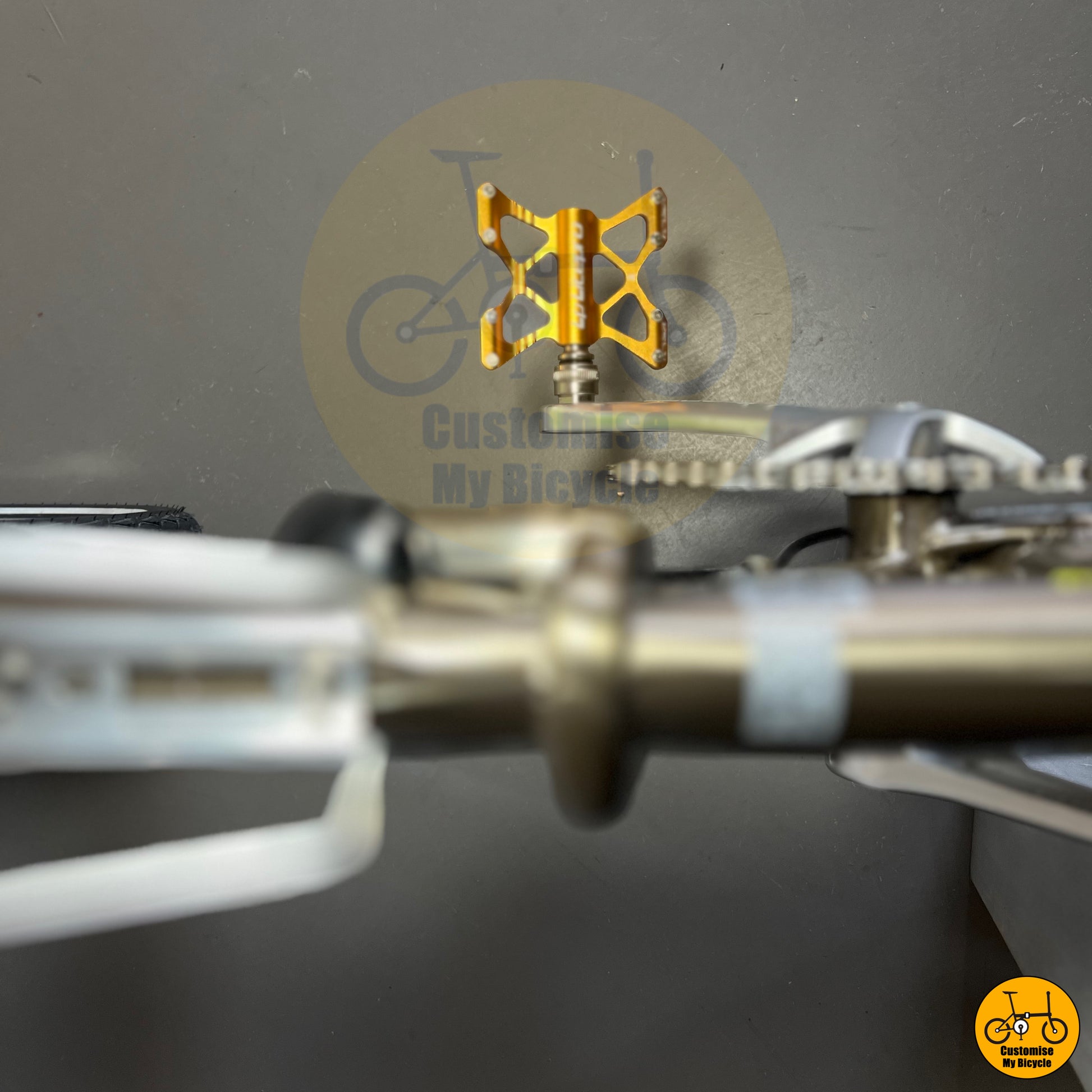 Litepro K5 quick release pedals on folding bicycle with an elegant titanium gold frame and polished parts
