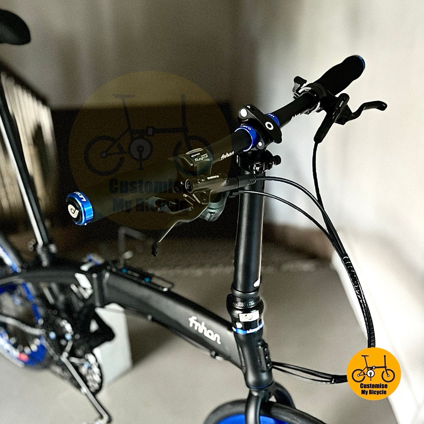 Close-up of a bicycle handlebar with visible branding and a blurred background