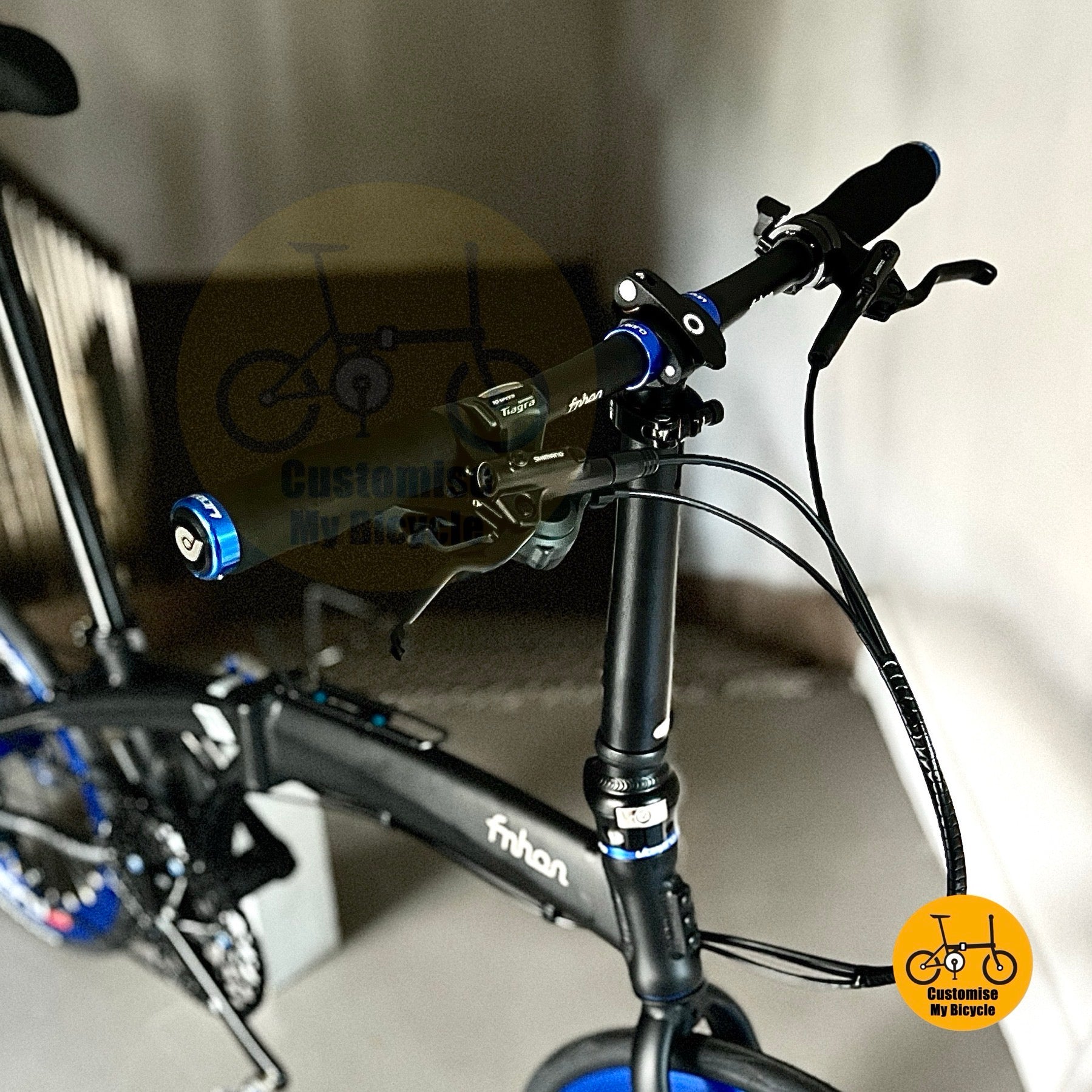 Close-up of a bicycle handlebar with visible branding and a blurred background