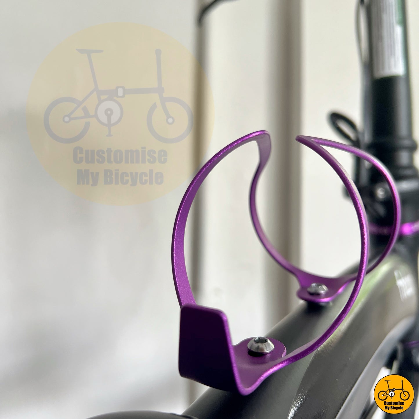 Purple bottle cage on compact foldable bike with custom purple highlights
