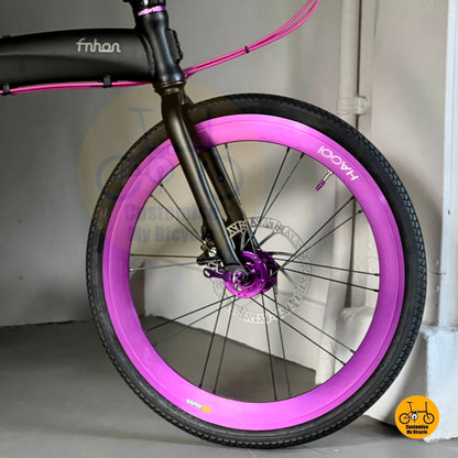 Foldie bike with round bar and purple wire  
