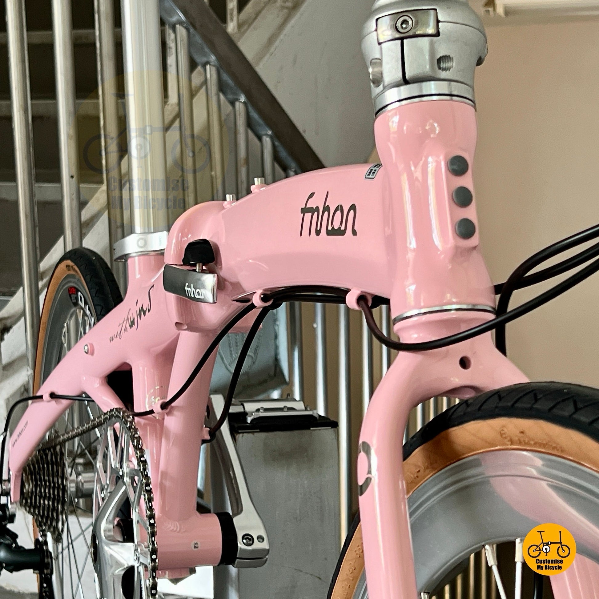 Lower front angle showing CST Ironkid tyres on Fnhon Wind Baby Pink folding bike  
