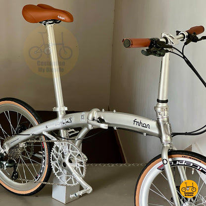 Three quarter front angle showing metallic silver aluminium frame and folding hinge
